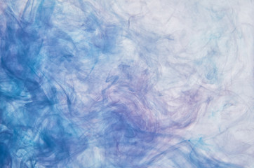 Red and blue acrylic ink in water on white background. Abstract background.