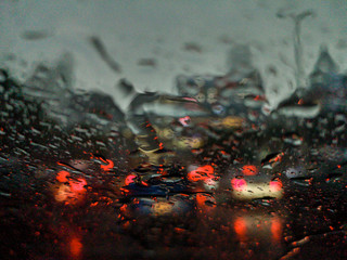 Colorful blurred abstract background from traffic jam on the road in rainy day.	
