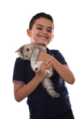 Obraz premium Happy Young Boy Smiling with Furry Kitten, Hugging His Pet, Isolated on White Background