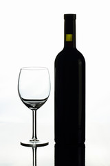 A bottle of red wine and a glass on a white background