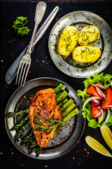 Grilled chicken fillet and vegetables on stone plate