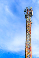 mobile phone communication and network signal repeater antenna tower with blue sky background