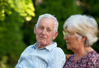 Old man and woman talking in park
