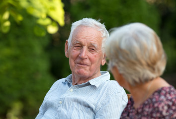 Old man and woman talking in park