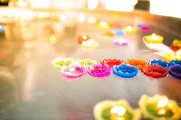 Floating colored lanterns-flower's candle on water.