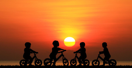 Fototapeta na wymiar Silhouette group boy friend and bike relaxing on sunrise