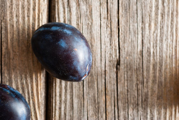 plums on old wood table directly above