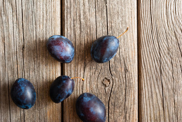 plums on old wood table directly above