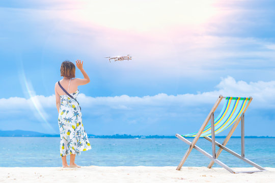 Women say hello to the drones. And colorful beach chairs Placed on the beach and peaceful sea