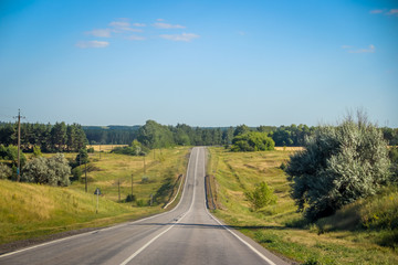 Fototapeta na wymiar Russian asphalt roads. Highway. Road trip. The car goes on the road. Background asphalt road.