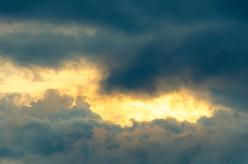 The golden light shines through the rain clouds.