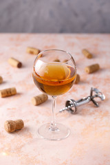 White wine in a glass. The concept of winemaking. Place under your text. Still life on a textural background.