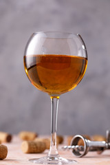 White wine in a glass. The concept of winemaking. Place under your text. Still life on a textural background.