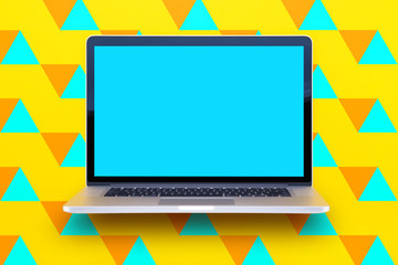 Computer staying on a table & showing the screen. Trendy & vibrant design. Geometry. Innovational digital internet applications & web business solutions. Modern workspace in an office. Development.