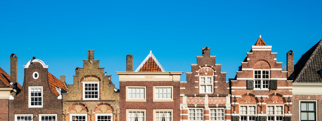 stepped gable Houses in street Nieuwstraat (Statenplein), Dodrecht. The Netherlands.  - obrazy, fototapety, plakaty