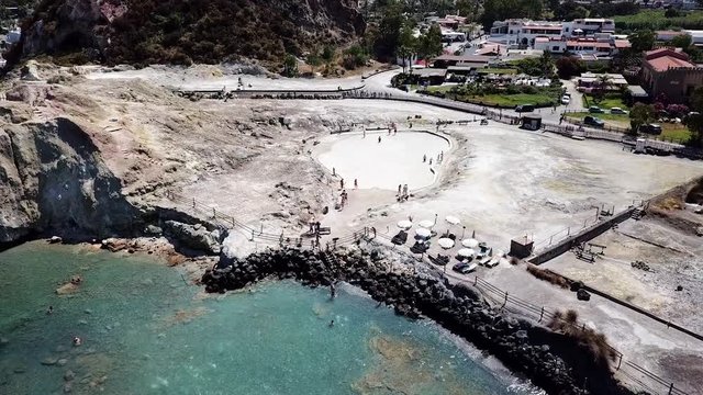 Aerial drone footage going towards the thermal mud baths of the Vulcano island in Sicily, Italy.
