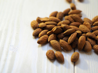 almond nuts on a light wooden surface