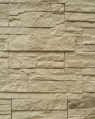 Close up abstract pattern of sandstone brick wall background in vintage tone style and vertical frame,