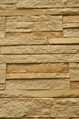 Close up abstract pattern of sandstone brick wall background in vintage tone style and vertical frame,