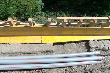 construction site with shawl panels and pipes ready for a concrete foundation along a railroad line