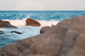 Waves breaking on the shore with sea foam
