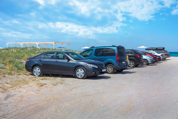 Fototapeta na wymiar Cars on a sandy beach