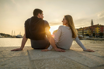 Fototapeta premium Happy couple of lovers relaxing on the sea pier.