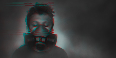 Young boy wearing gasmask, respirator portrait. Effects of worldwide air pollution, industrial...