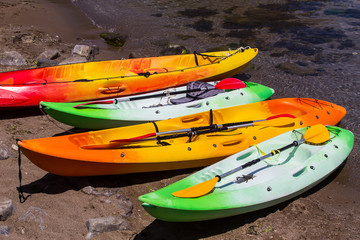 plastic boats with oars near the sea