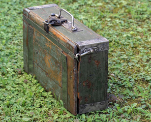 German wooden suitcase with metal handle in meadow. Used by the German Army in the Second World War