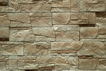 Close up abstract pattern of sandstone brick wall background in vintage tone style and vertical frame,