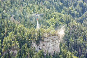 Fire helicopter extinguishes fire in the forest, Big Fatra, Slovakia