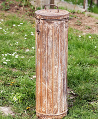 Naklejka premium An old metal cassette the form of a roller in the garden.Used in the Second World War by the German army.