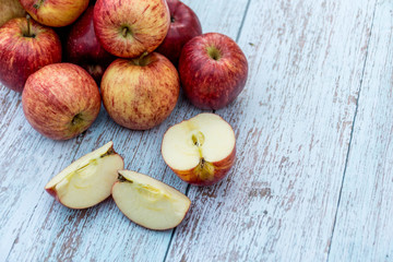 Organic ripe apples on a wooden table. Fresh cut apple healthy snack. Cooking ingredients. Harvest.