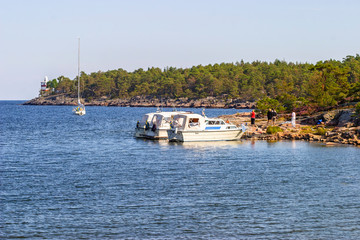 Fototapeta na wymiar Boats in a natural harbor by an island