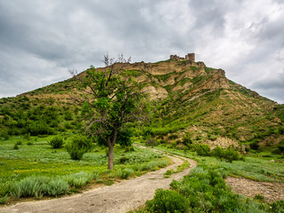 Dirt road leading to ancient Ksani Fortress in Georgia