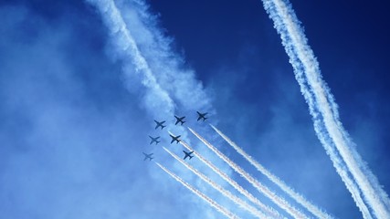 airshow in sky by bright sea and traced lines - obrazy, fototapety, plakaty
