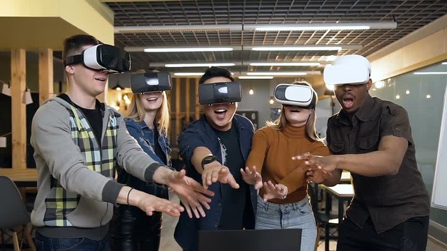Hipster team of business people in vr virtual reality glasses having fun in the modern office.