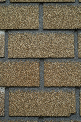 Close up abstract pattern of sandstone brick wall background in vintage tone style and vertical frame,