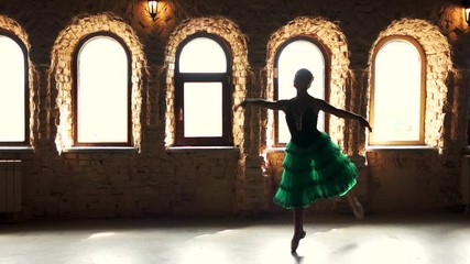 Elegant ballerinas dance in ballet studio. Slow motion beautiful dancer in green dress dancing in fashion studio on windows background. - Powered by Adobe