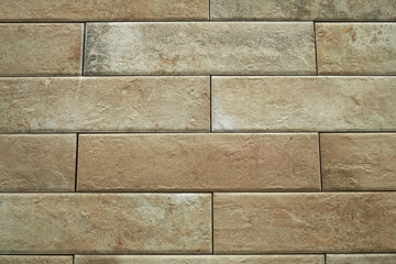 Close up abstract pattern of sandstone brick wall background in vintage tone style and vertical frame,