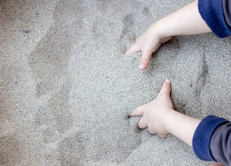 Cute kid playing with sand
