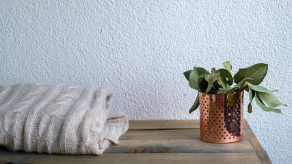 Folded knitted plaid on white background. Warm and cozy home, banner, selected focus