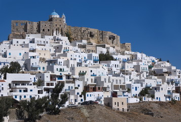 Fototapeta na wymiar Greece, the island of Astypalaia and its castle. Whitewashed buildings cluster around the venerable and historic Querini fortress.