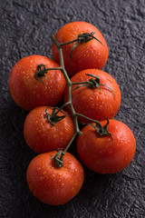 Fresh tomatoes on a dark background. Top view
