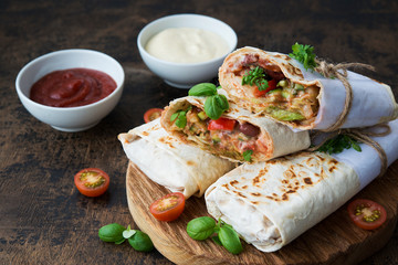 Mexican wrapped burrito with red beans and vegetables