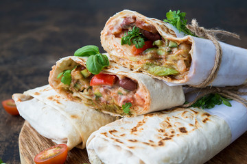 Mexican wrapped burrito with red beans and vegetables