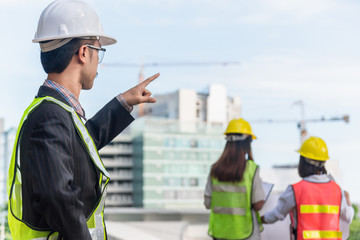 Construction Worker Planning Contractor Checking at factory construction. A man hold tablet for working.