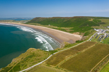 Aerial drone view of the beautiful, huge sandy beach at Rhossili on the Gower Peninsula in Wales