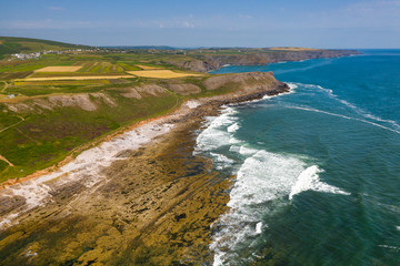 Aerial view of cliffs and waves on the Worm's Head area of the Gower peninsula